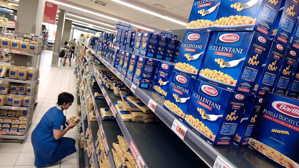 PHOTO: An employee stocks Barilla pasta on supermarket shelves near Milan, Italy, Sept. 13, 2007.