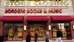 PHOTO: Pedestrians pass by a Borders book store with signs announcing that it will be closing its doors, March 4, 2001, in Washington.