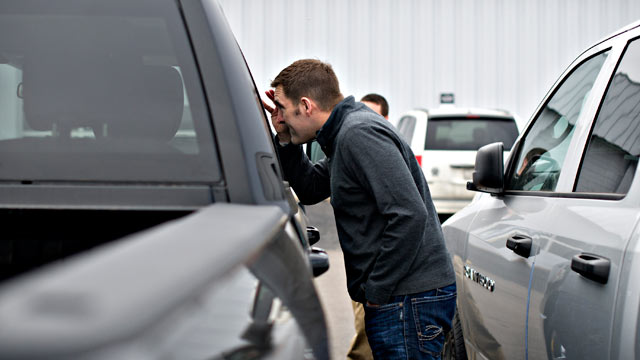 PHOTO: Joe DeLucia looks over a pickup truck as he shops for a vehicle in Peoria, Illinois.