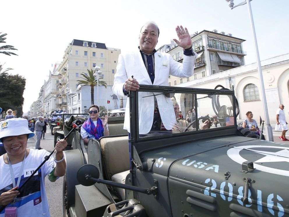 PHOTO: Li Jinyuan, CEO of Tiens rides in a parade on May 8, 2015 in Nice, France as part of the two-day celebration weekend for the 20th anniversary of his company.