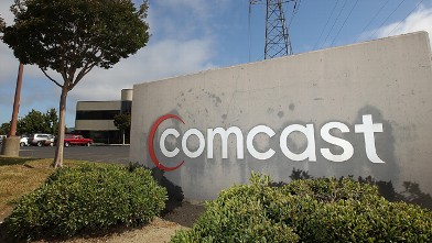 PHOTO: 	A sign stands in front of a Comcast customer service center in San Rafael, Calif.