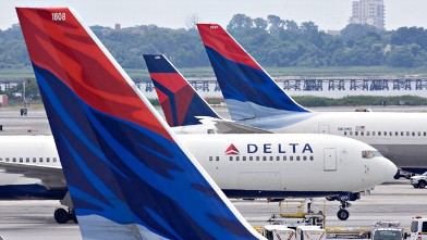 PHOTO: A Delta Air Lines plane taxis toward a gate between other Delta planes at John F. Kennedy International Airport in New York, U.S., on July 20, 2009.