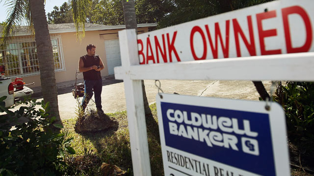PHOTO: Renzo Salazar maintains the yard around a foreclosed home after the bank hired him to keep the home from falling into complete dilapidation on November 10, 2011 in Miami, Florida.