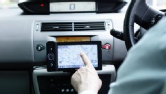 PHOTO: A businessman uses GPS navigation system in his car.