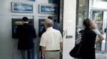 PHOTO: People withdraw money from a branch of National Bank of Greece in central Athens on May 17, 2012.