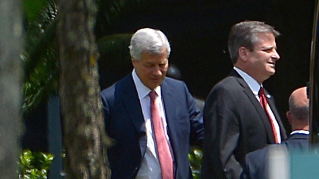 PHOTO: Jamie Dimon, chairman and CEO of JPMorgan Chase, left, and an unidentified man leave the companys annual shareholders meeting in Tampa, Fla., May 21, 2013.