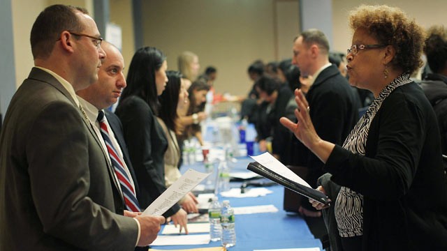 PHOTO: Job seekers speak with perspective employers at the New York Career Fair held at a midtown Holiday Inn in this Dec. 12, 2011 file photo in New York City.