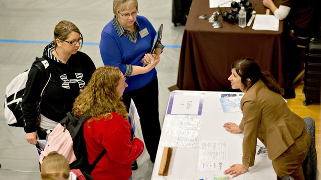 PHOTO: Job seekers speak to a representative at a job fair at Illinois Valley Community College (IVCC) in Oglesby, Ill. on April 10, 2013.