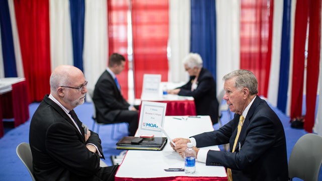 PHOTO: Jerry Crews, right, critiques the resume of a job seeker at the Military Officers Association of America career fair, April 24, 2012 in Washington, DC.