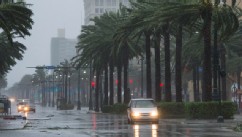 PHOTO: A vehicle travels down Canal Street as Hurricane Isaac dumps heavy rain on August 29, 2012 in New Orleans, La.