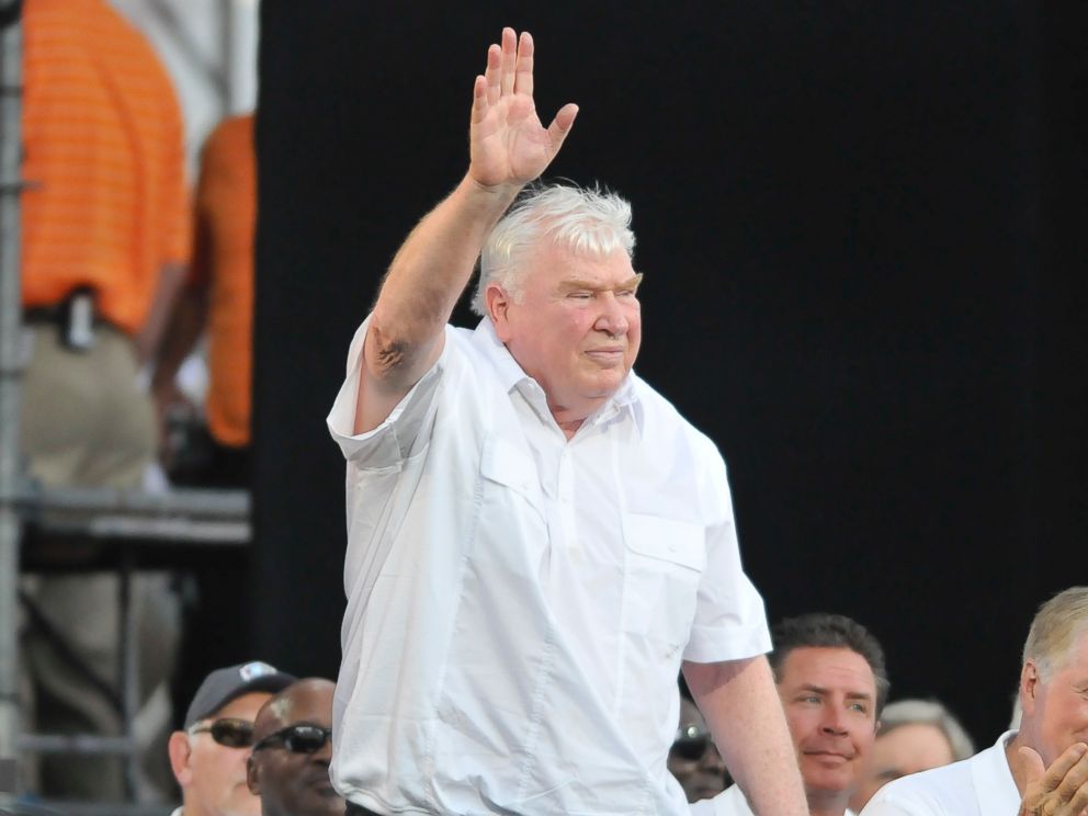 PHOTO: Former NFL coach John Madden waves to the crowd after being introduced before the 2012 Pro Football Hall of Fame Enshrinement ceremony on August 4, 2012, at Fawcett Stadium in Canton, Ohio.