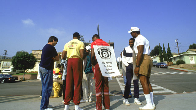 PHOTO: Members of the Los Angeles Raiders stand in a picket line during the NFL Players Union Strike in September 1987.