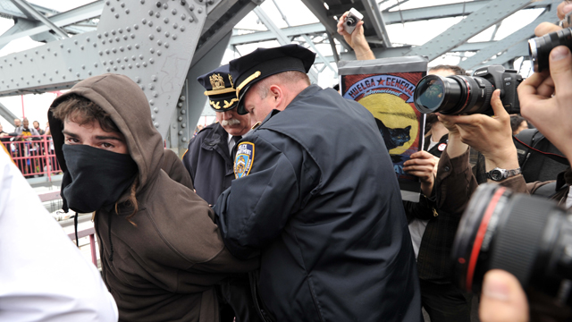 PHOTO: A police officer arrests a mask-wearing Occupy Wall Street protester on the Williamsburg Bridge during a march to Manhattan as the movement joins with activists groups for May Day demonstrations May 1, 2012 in New York.