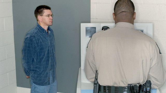 PHOTO: Man having his mugshot taken