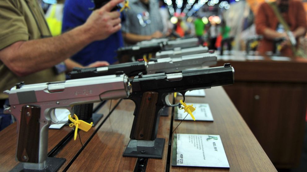 PHOTO: Convention goers look at various models of Ruger 1911 model semi-automatic pistols during the National Rifle Association convention at the George R. Brown Convention Center May 4, 2013 in Houston, Texas.