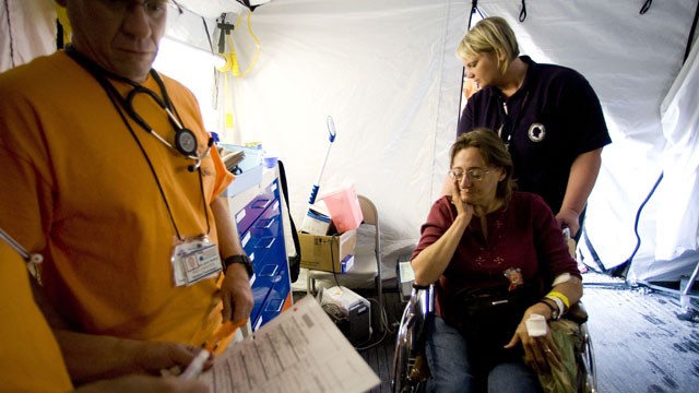 PHOTO: An unidentified woman is wheeled out of the emergency tent to be taken to hospital, at the Remote Area Medical (RAM) clinic in Wise, Virginia. Rural families, most with little or no insurance, lined up for hours to receive free health care from hu