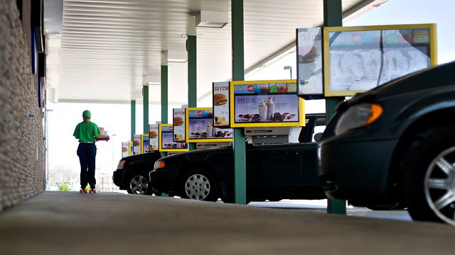 PHOTO: An employee delivers food at a Sonic Corp. drive-in restaurant in Normal, Ill., March 20, 2012.