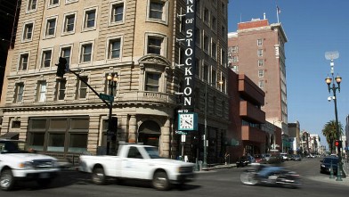 PHOTO: Cars drive through the downtown area in Stockton, California.