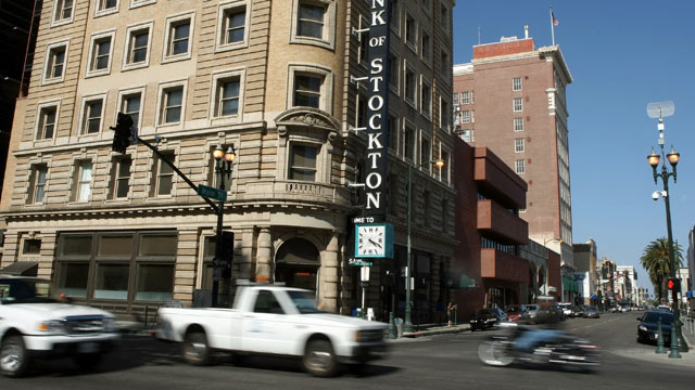 PHOTO: Cars drive through the downtown area in Stockton, California.