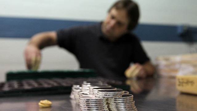 PHOTO: A worker sorts trays of silver blanks that will be used for the National Medals at the West Point Mint, May 18, 2012 in West Point, New York.