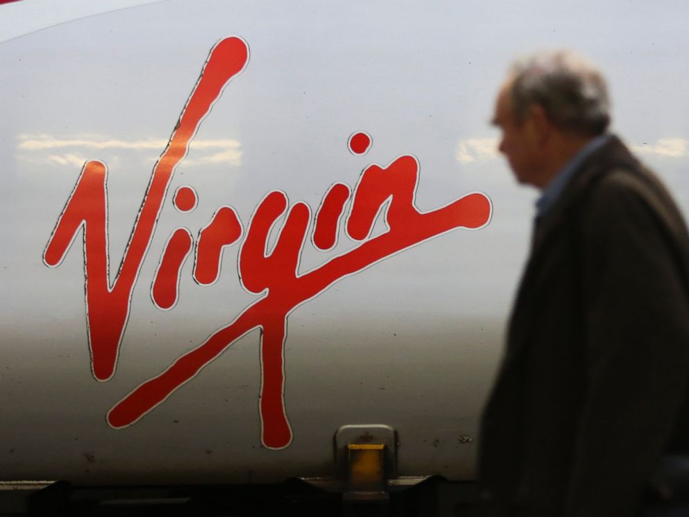 PHOTO: The Virgin logo sits on the side of a West Coast train, operated by Virgin Trains, as it stands beside a platform at Euston railway station in London, Nov. 27, 2014.