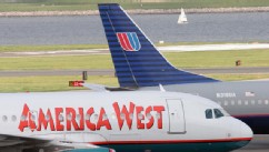 PHOTO: America West and United Airlines passenger jets taxis on the runway at Reagan National Airport Monday, May 16, 2005 in Washington, DC.
