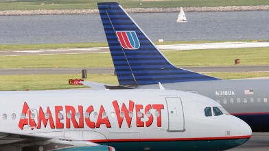 PHOTO: America West and United Airlines passenger jets taxis on the runway at Reagan National Airport Monday, May 16, 2005 in Washington, DC.