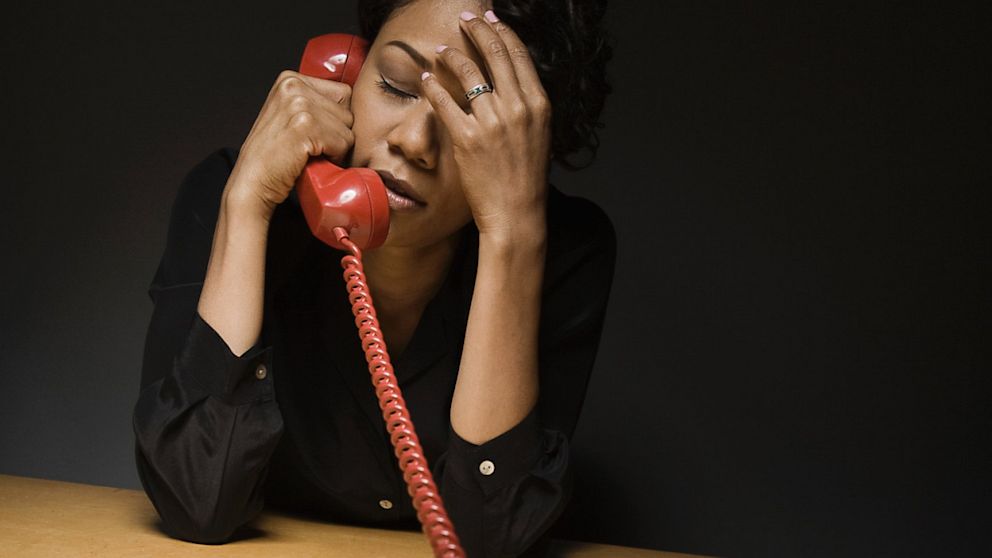 PHOTO: Exasperated woman on telephone