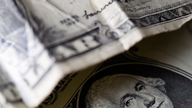 PHOTO: Crumpled dollar bills.