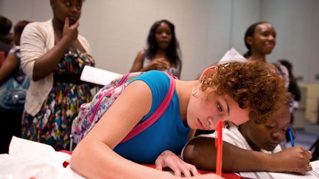 PHOTO: Jhada Thomas, 15, right, Alexis Lucero, 15, left, fill out job applications for Red Mango Inc. during The Summer Youth Jobs & Training Expo 2012 at the Colorado Convention Center in Denver, Colorado, U.S., on May 18, 2012.