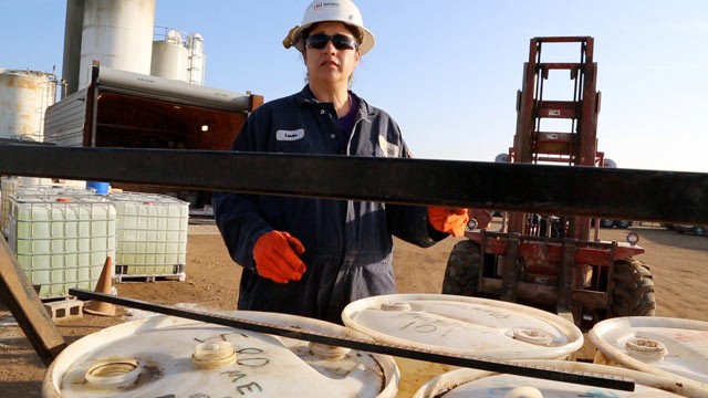 PHOTO: Linda Trujillo mixes chemicals used in the fracking process. She moved her family from New Mexico to Kansas after hearing about the money being made working in the oil fields.