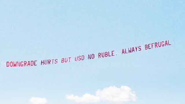 PHOTO: "Downgrade hurts but USD no ruble. Always be frugal," was the message on the banner over the Financial District, August 11, 2011, paid for by Jon Lal, 43, a Boston-based businessman who runs a website, befrugal.com.