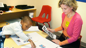 PHOTO University of Michigan professor T. Bettina Cornwell observes as a young boy creates collages to represent soft drink brands Coke and Pepsi
