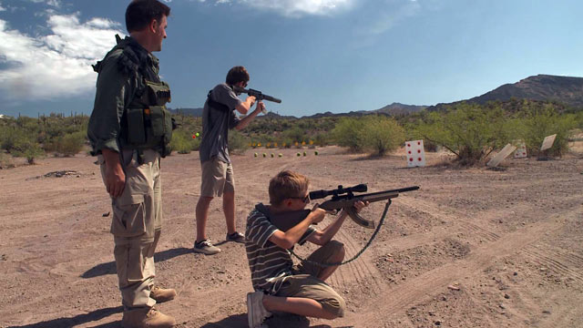 PHOTO: Tim Ralston trains his children in the use of firearms so they are prepared for doomsday.