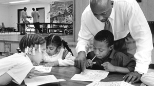 PHOTO Earl Phalen tutors first and second grade students in Dorchester, Mass., in this 1998 file photo.