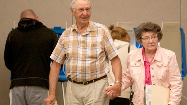 PHOTO: Wallace and Evelyn Feltman walk to the ballot box after filling out their ballots at the Alerus Center, Grand Forks, North Dakota, June 12, 2012.