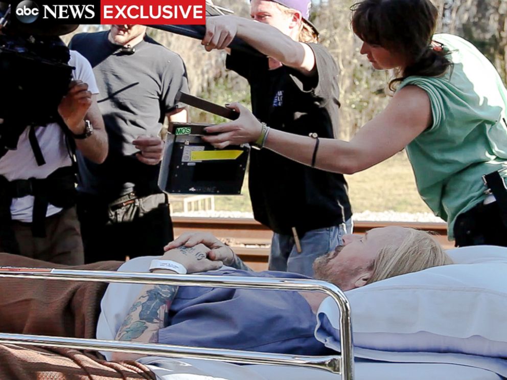 PHOTO: Actor William Hurt lays in a hospital bed on the set of Midnight Rider, just moments before the train accident that killed Sarah Jones, pictured on the far right.