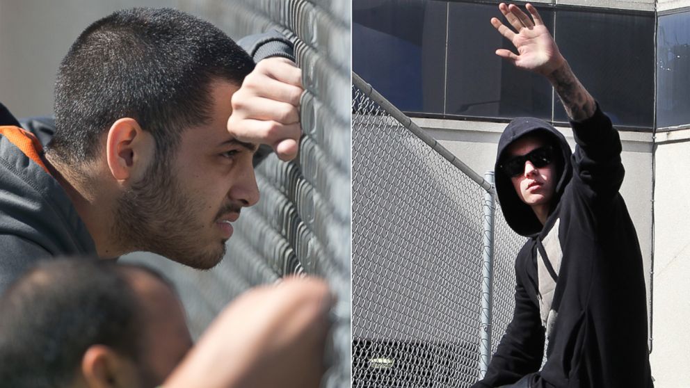 PHOTO: Fans and onlookers gathered outside the correctional facility where Justin Bieber was being held following his arrest in Miami Beach, Jan. 23, 2014. Bieber (right) later emerged and waved to the crowd.