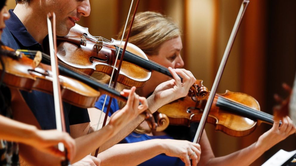 PHOTO: In this March, 27, 2014 photo, three violinists play Stradivarius violins during a rehearsal at the Colburn School in Los Angeles.  