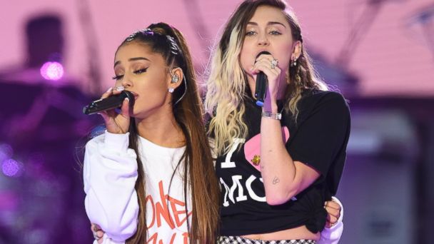 PHOTO: Ariana Grande, left, and Miley Cyrus perform on stage at the 'One Love Manchester' benefit concert, June 4, 2017 in Manchester, England.