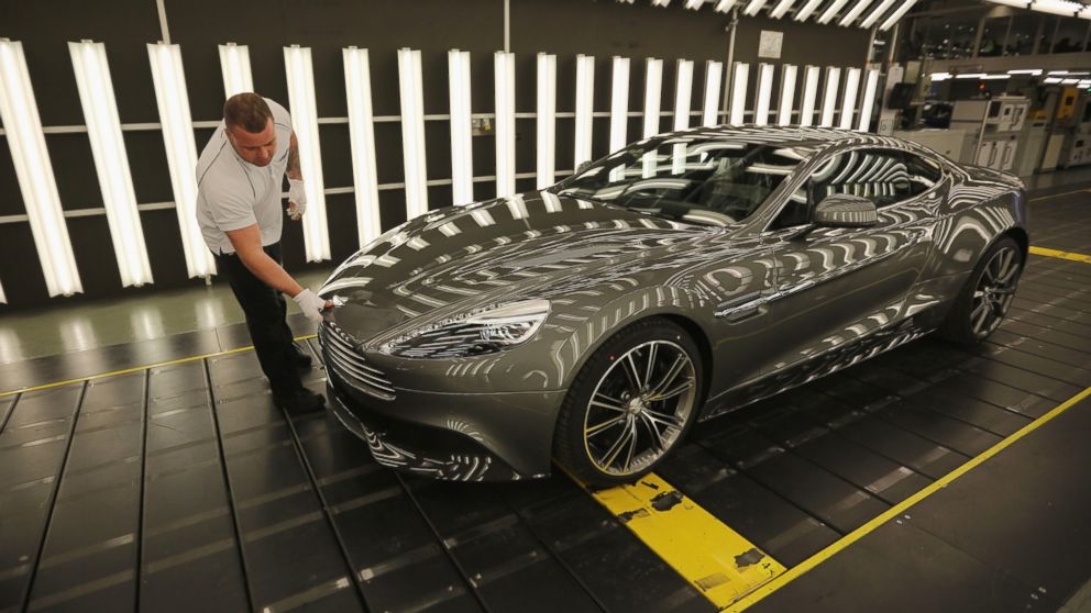 PHOTO: In this file photo, an Aston Martin Vanquish is inspected by hand inside a light booth at the company headquarters and production plant on Jan. 10, 2013 in Gaydon, England. 