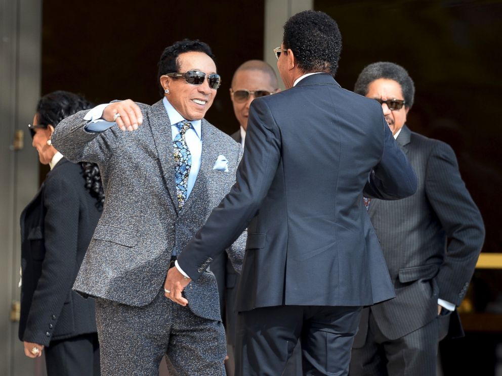 PHOTO: Smokey Robinson hugs Lionel Richie as they arrive for a funeral service for singer Natalie Cole in Los Angeles, Jan. 11, 2016.