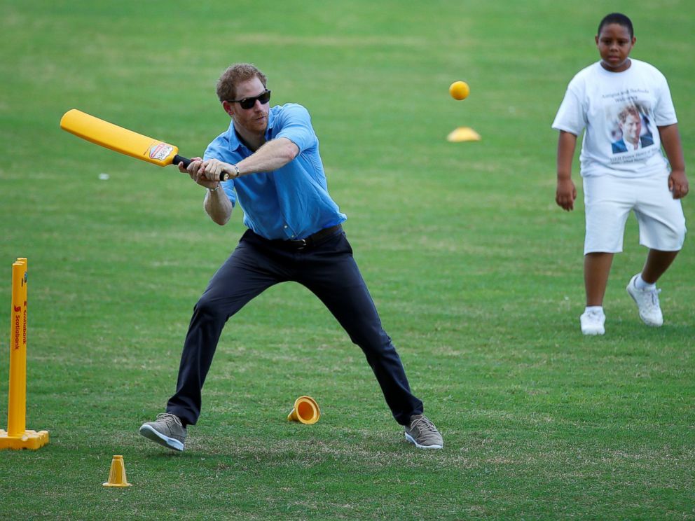 PHOTO: Britain's Prince Harry hits the ball while he plays cricket with children in an exhibition match during his official visit in Antigua, Nov. 21, 2016.  