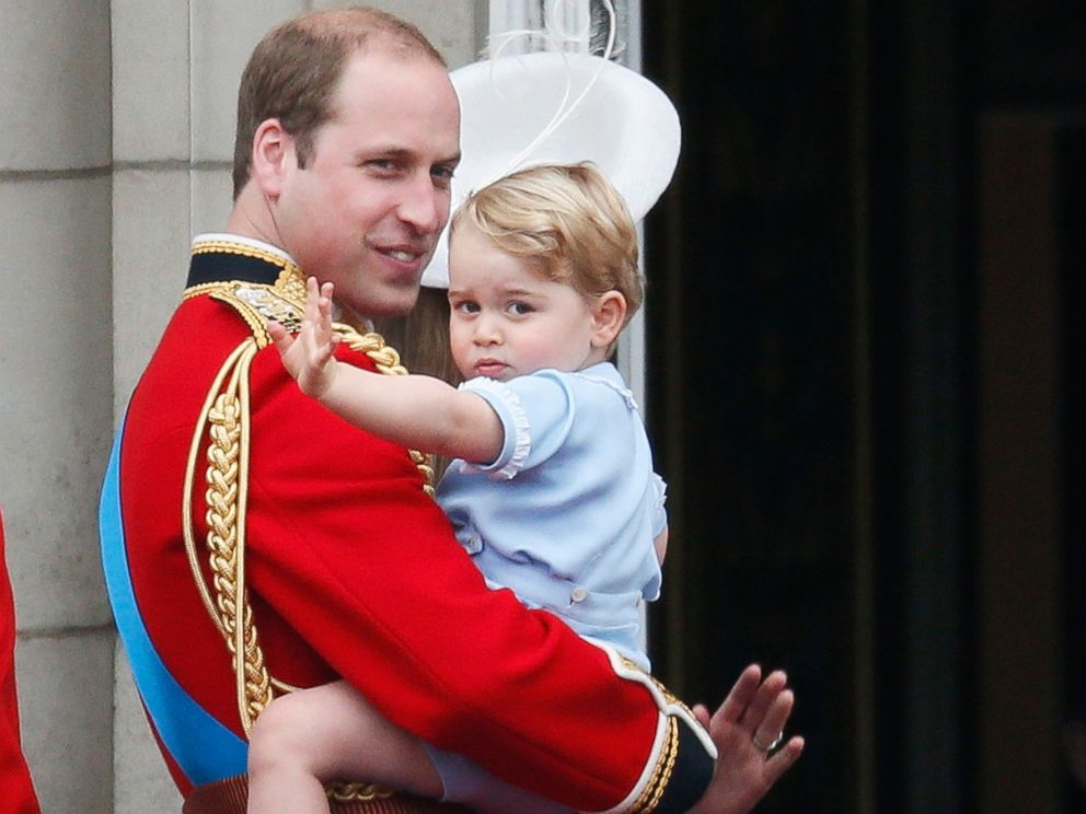 PHOTO: Britains Prince William holds Prince George as he waves from the balcony at Buckingham Palace after the Trooping The Color ceremony in central London, June 13, 2015.