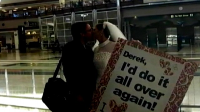 VIDEO: Lacy Matthews surprised her husband at a Denver airport wearing her gown on their anniversary.