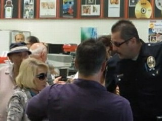 Joan Rivers Chains Herself to Shopping Cart in Protest