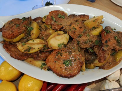 Emeril's braised pork chops with apples and onions are shown here.