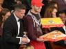 PHOTO: Brad Pitt, left, and Ellen DeGeneres, right, pass out pizza in the audience during the Oscars at the Dolby Theatre on March 2, 2014, in Los Angeles.  