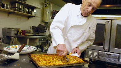PHOTO: Henry Hill cuts a tray of pizza in the kitchen of the Firefly restaurant where he cooks in North Platte, Neb., Feb. 22, 2005.