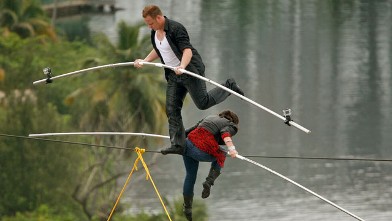 PHOTO: High-wire acrobats Delilah Wallenda, right, lowers her head as her son Nik Wallenda, left, crosses over her during their high-wire act where the two simultaneously walked across a 300-foot-long wire suspended 100 feet in the air between two towers 